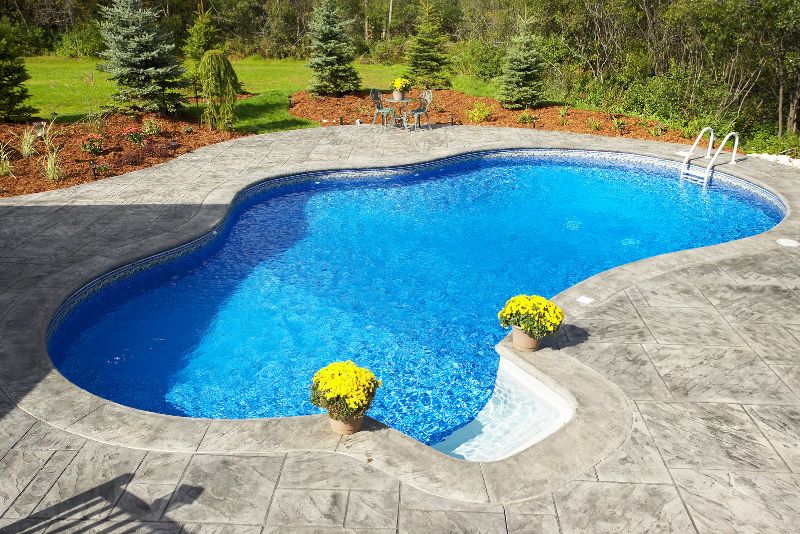 home backyard pool deck made of concrete