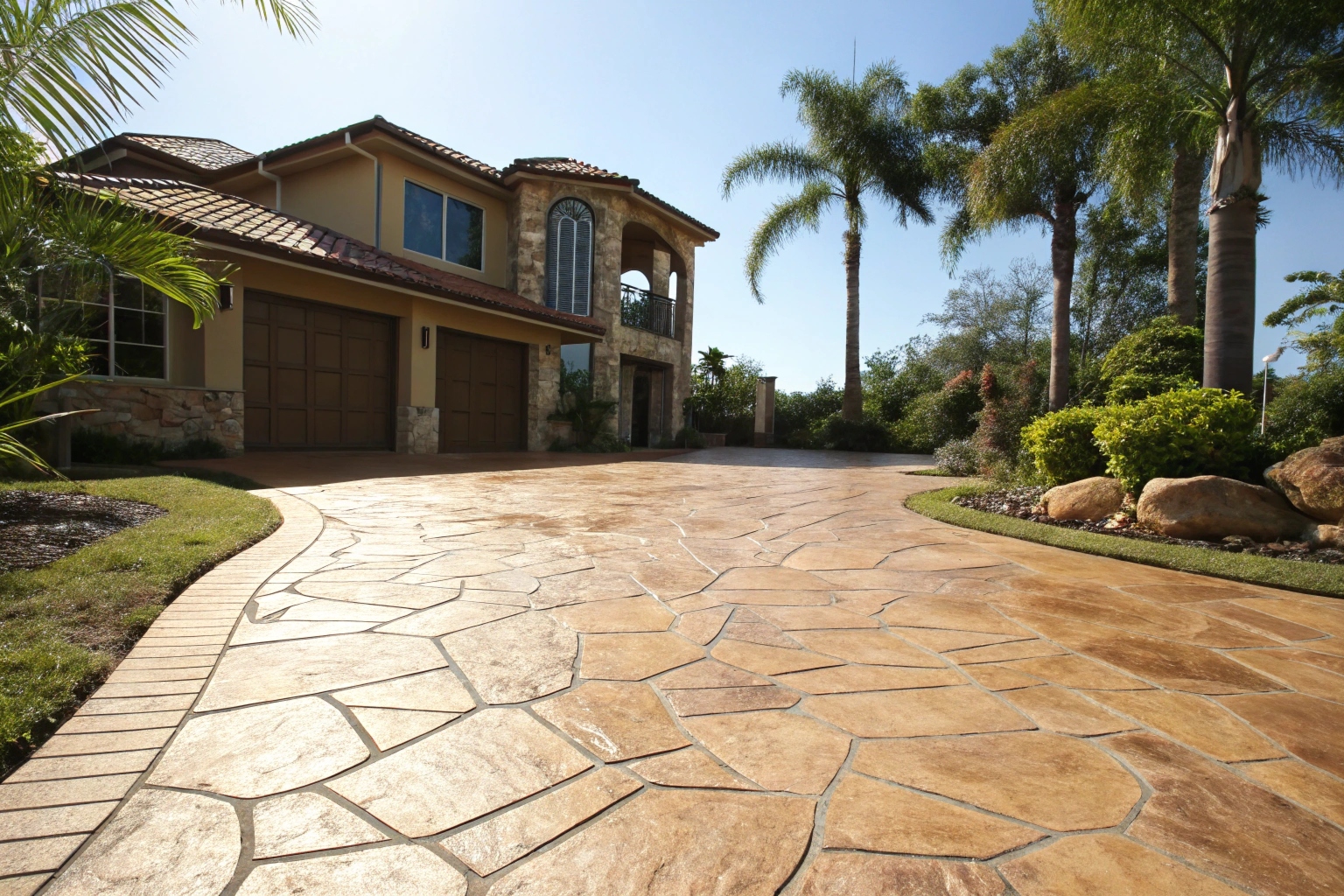 Stamped concrete driveway with natural stone pattern in Ipswich home
